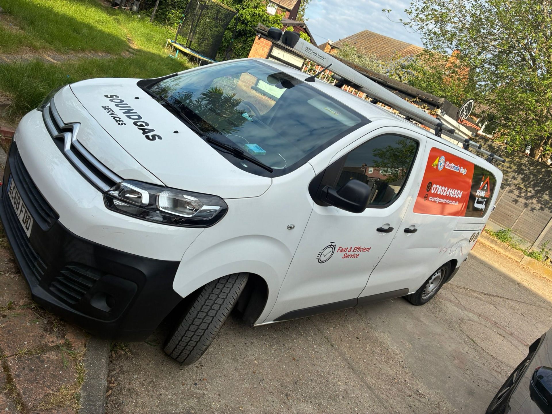 Sound Gas Services Gas Safe registered engineer with branded van outside an East London home